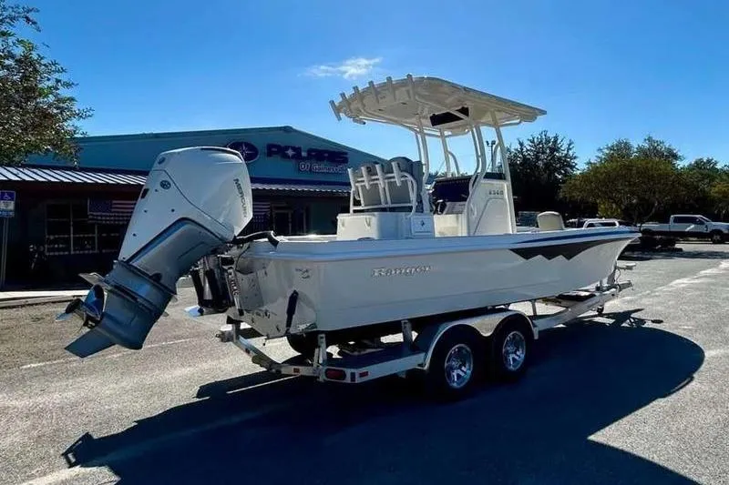 Slide: The Image of 2026 Ranger 2360 Bay boat on trailer, parked outdoors under clear sky. - 5