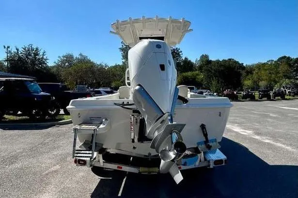 Slide: The Image of 2026 Ranger 2360 Bay boat with powerful outboard motor, parked outdoors. - 6