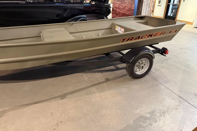 Slide: The Image of 2026 Tracker Grizzly 14 Jon boat on trailer in showroom. - 2