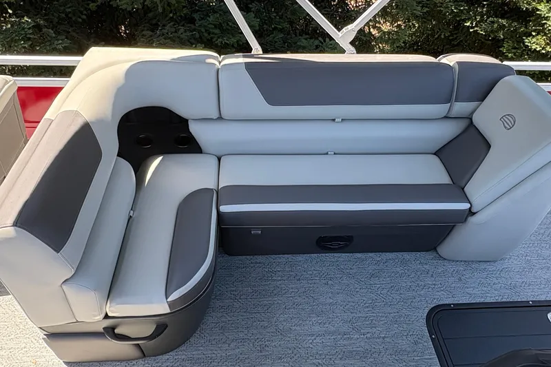 Slide: The Image of 2026 Sun Tracker Fishin' Barge 22 XP3 interior seating with gray upholstery and cup holders. - 15