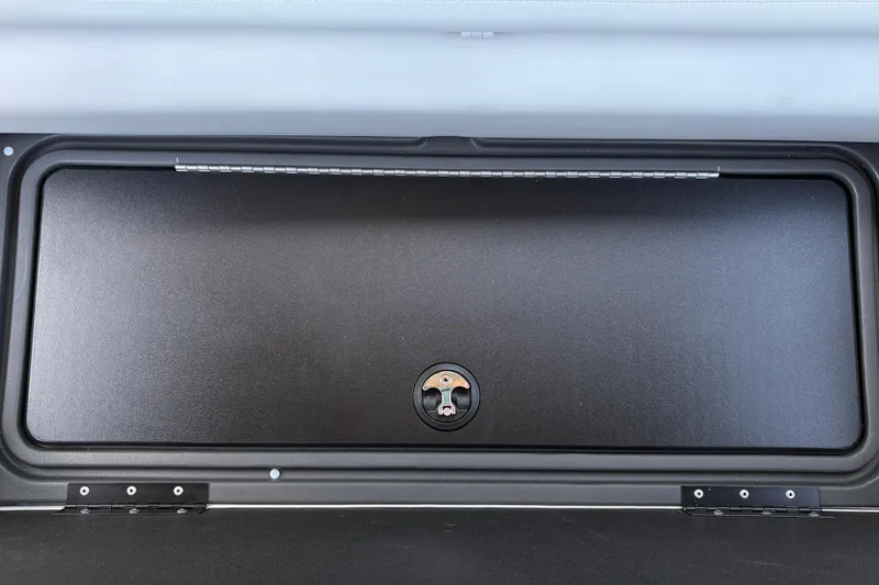 Slide: The Image of Storage compartment on 2026 Sun Tracker Fishin' Barge 22 XP3 boat, featuring secure latch. - 50