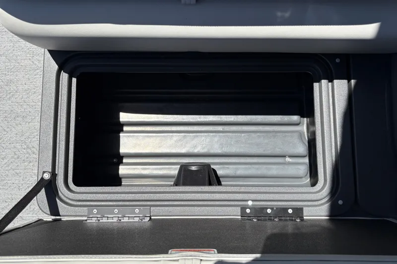 Slide: The Image of Storage compartment of 2026 Sun Tracker Fishin' Barge 22 XP3, open and empty. - 38