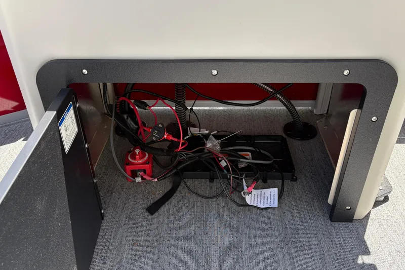 Slide: The Image of Battery compartment of 2026 Sun Tracker Fishin' Barge 22 XP3 with wiring and switch. - 32