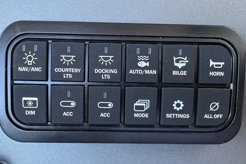 Slide: The Image of Control panel of a 2026 Sun Tracker Fishin' Barge 22 XP3 with various function buttons. - 34