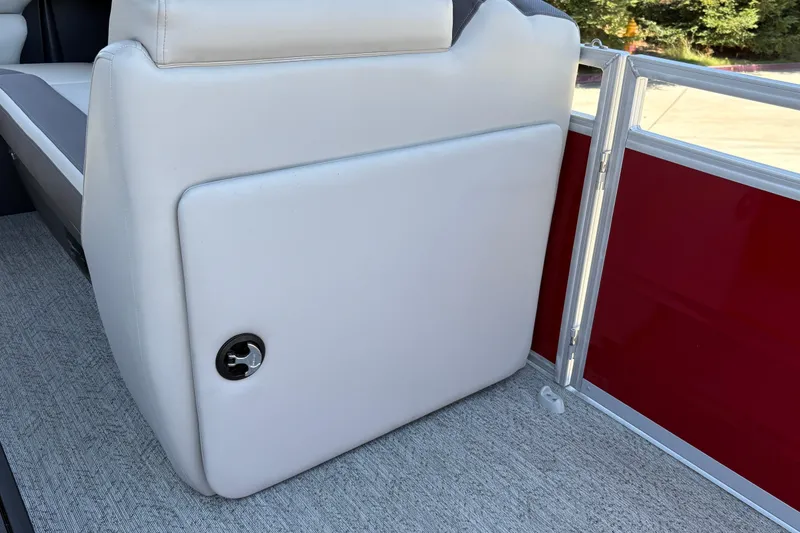 Slide: The Image of 2026 Sun Tracker Fishin' Barge 22 XP3 interior seating detail with red paneling. - 29