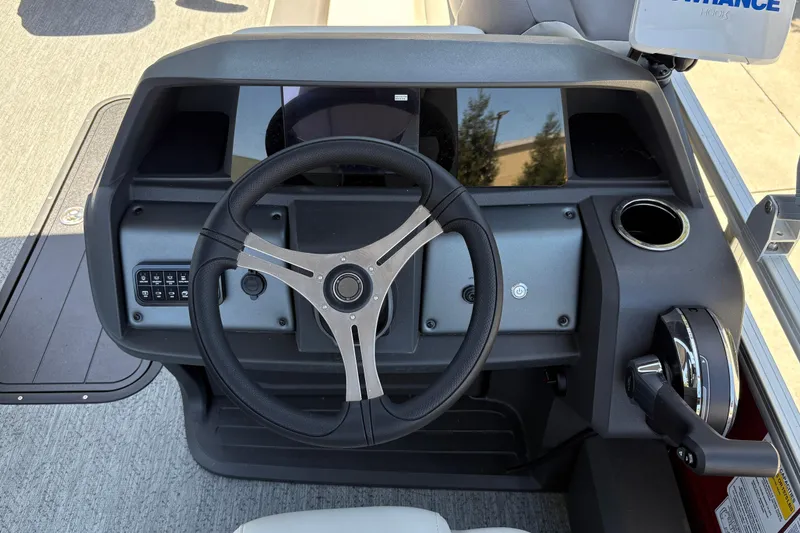 Slide: The Image of 2026 Sun Tracker Fishin' Barge 22 XP3 dashboard with steering wheel and controls. - 25