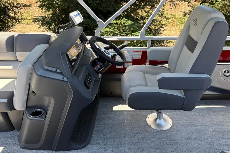 Slide: The Image of 2026 Sun Tracker Fishin' Barge 22 XP3 helm with comfortable captain's chair and modern controls. - 8
