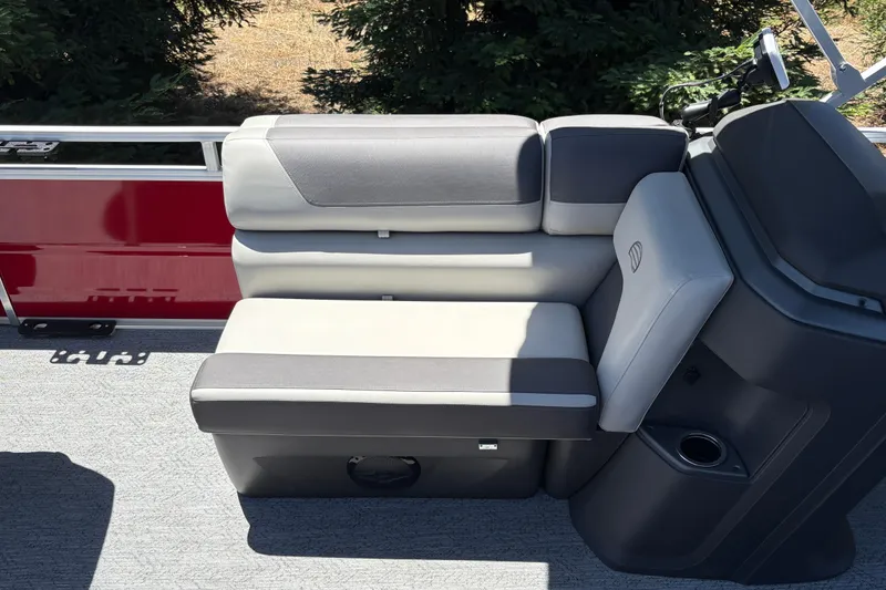 Slide: The Image of 2026 Sun Tracker Fishin' Barge 22 XP3 interior seating with gray upholstery and cup holder. - 40