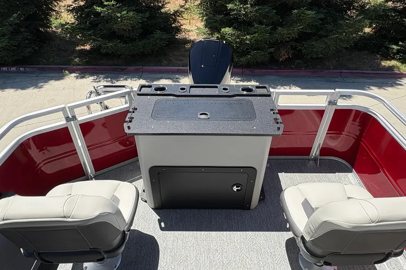Slide: The Image of 2026 Sun Tracker Fishin' Barge 22 XP3 interior with seating and control panel. - 14