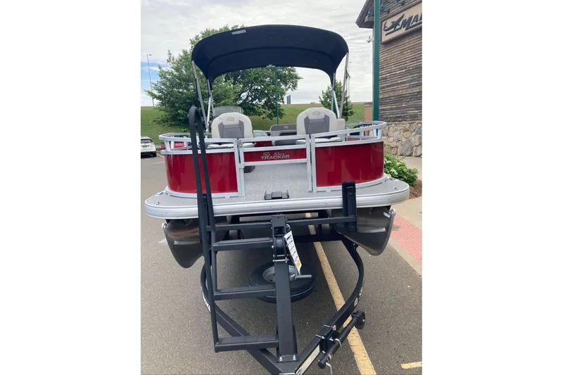 Slide: The Image of 2026 Sun Tracker Bass Buggy 16 XL Select pontoon boat on trailer, rear view. - 2