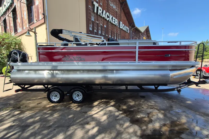 The Image of 2026 Sun Tracker Fishin' Barge 22 XP3 pontoon boat displayed at Tracker Boats dealership. - 0