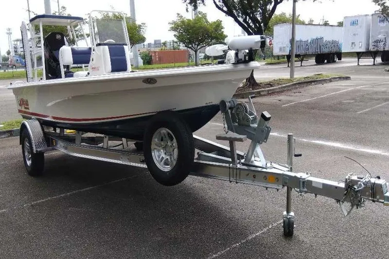 Slide: The Image of 2026 Mako 18 Pro Skiff Patriot Edition on trailer in parking lot. - 4