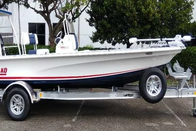Slide: The Image of 2026 Mako 18 Pro Skiff Patriot Edition boat on trailer, side view. - 7