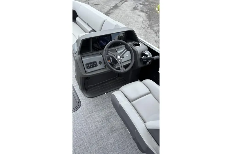 Slide: The Image of 2026 Sun Tracker Party Barge 22 XP3 helm with modern steering and controls. - 2