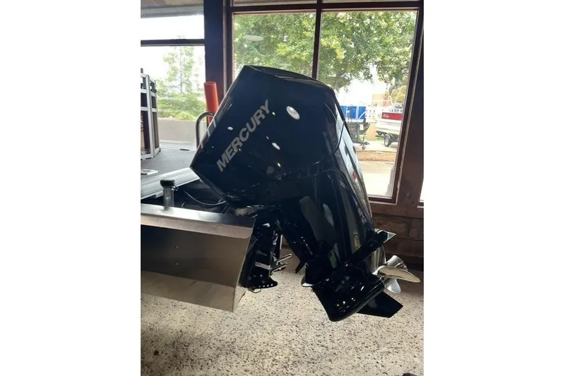 Slide: The Image of 2026 Sun Tracker SportFish 22 XP3 with Mercury outboard motor in showroom. - 5