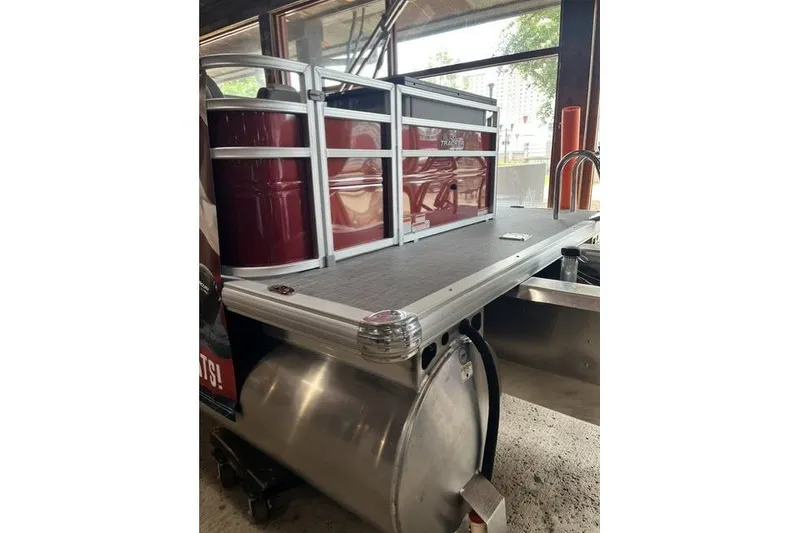 Slide: The Image of 2026 Sun Tracker SportFish 22 XP3 pontoon boat, rear view with red paneling and aluminum frame. - 6
