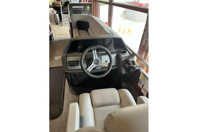 Slide: The Image of 2026 Sun Tracker SportFish 22 XP3 boat interior with steering wheel and seating. - 1