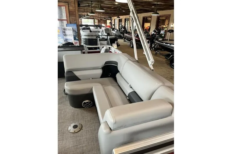 Slide: The Image of 2026 Sun Tracker SportFish 22 XP3 pontoon boat interior with gray seating in showroom. - 9