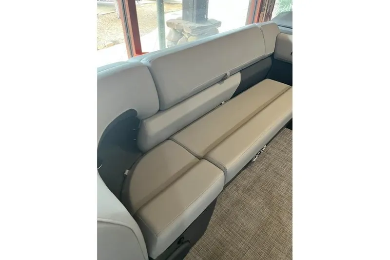 Slide: The Image of 2026 Sun Tracker SportFish 22 XP3 boat interior seating, featuring comfortable beige upholstery. - 11