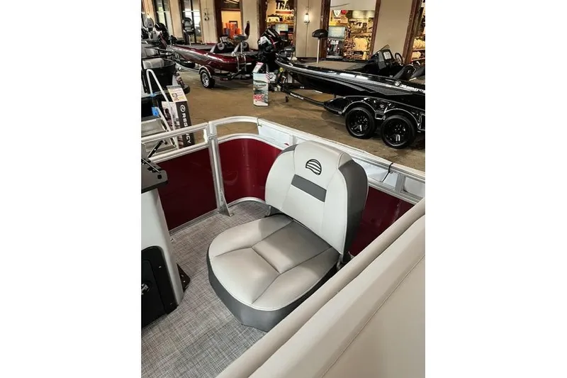 Slide: The Image of 2026 Sun Tracker SportFish 22 XP3 boat interior with comfortable seating in showroom. - 8
