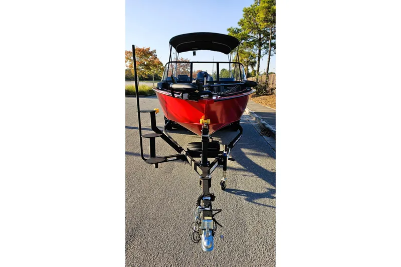 Slide: The Image of 2026 Tracker Targa V-19 Combo boat on trailer, parked outdoors. - 11