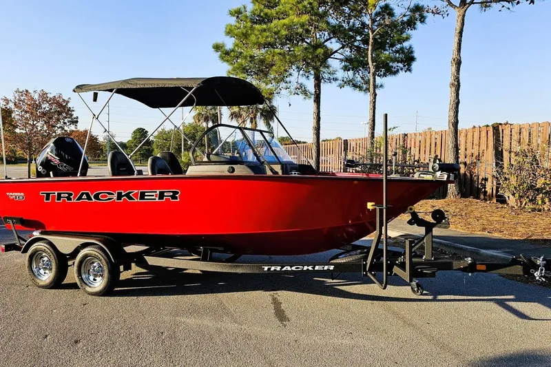 Slide: The Image of 2026 Tracker Targa V-19 Combo boat on trailer, side view, beige color. - 2