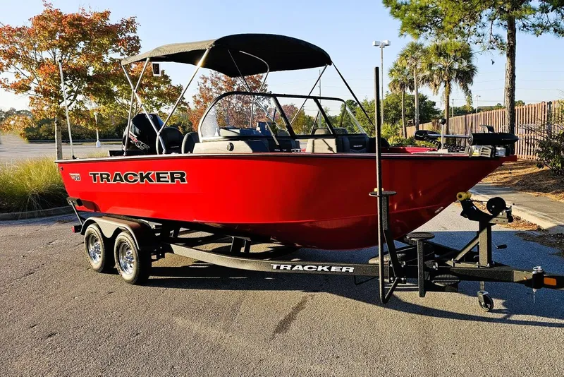 Slide: The Image of 2026 Tracker Targa V-19 Combo boat in vibrant red on a trailer, parked outdoors. - 3