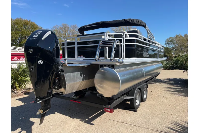Slide: The Image of 2026 Sun Tracker Fishin' Barge 22 XP3 pontoon boat on trailer, rear view. - 76