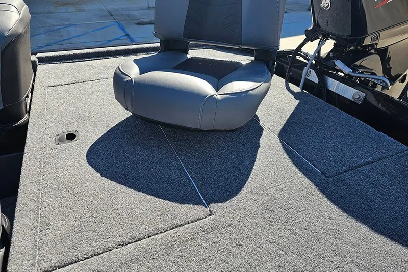 Slide: The Image of 2026 Tracker Bass Tracker Classic XL boat with cushioned seat on carpeted deck. - 10