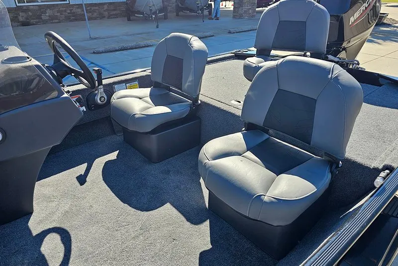 Slide: The Image of 2026 Tracker Bass Tracker Classic XL boat interior with gray seating and steering console. - 12