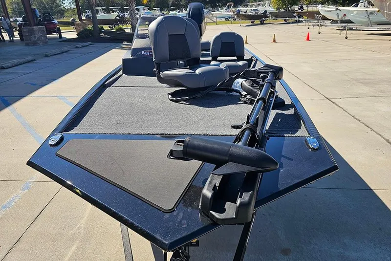 Slide: The Image of 2026 Tracker Bass Tracker Classic XL boat with seating and trolling motor in a marina. - 4
