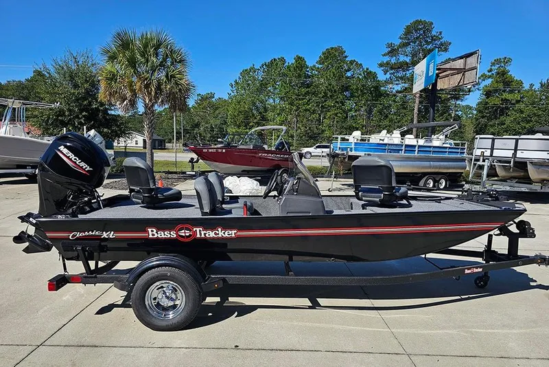 Slide: The Image of 2026 Tracker Bass Tracker Classic XL boat on trailer, parked outdoors. - 6