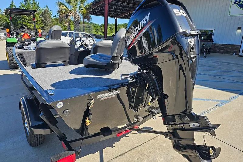 Slide: The Image of 2026 Tracker Bass Tracker Classic XL boat with Mercury 50 engine, parked outdoors. - 9