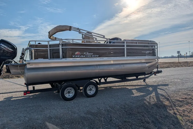Slide: The Image of 2024 Sun Tracker SportFish 20 DLX pontoon boat on trailer, parked outdoors. - 69