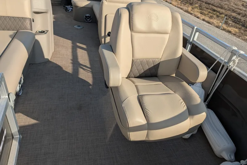 Slide: The Image of 2024 Sun Tracker SportFish 20 DLX boat interior with beige seating and carpeted floor. - 74