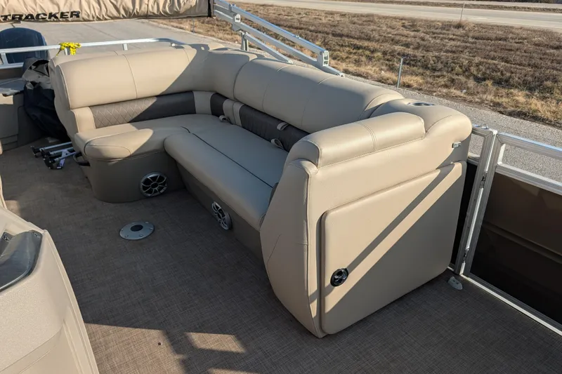 Slide: The Image of 2024 Sun Tracker SportFish 20 DLX boat interior with beige seating and carpeted floor. - 76