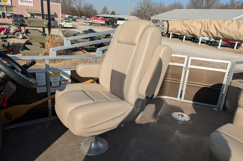 Slide: The Image of 2024 Sun Tracker SportFish 20 DLX boat interior with beige captain's chair and steering wheel. - 79