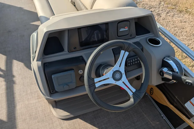 Slide: The Image of 2024 Sun Tracker SportFish 20 DLX boat dashboard with steering wheel and controls. - 81