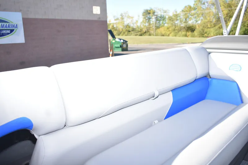 Slide: The Image of 2026 Sun Tracker Party Barge 20 DLX interior seating with white and blue upholstery. - 10