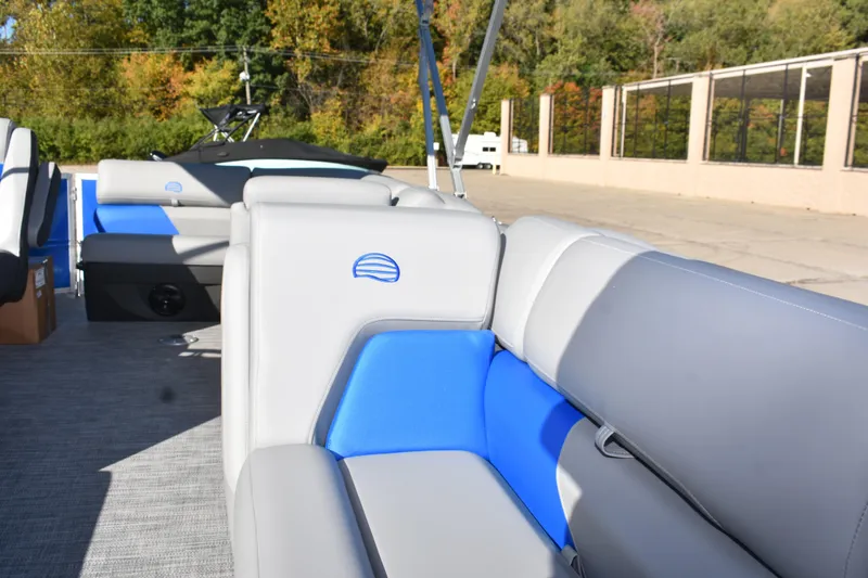 Slide: The Image of 2026 Sun Tracker Party Barge 20 DLX interior with gray and blue seating. - 11