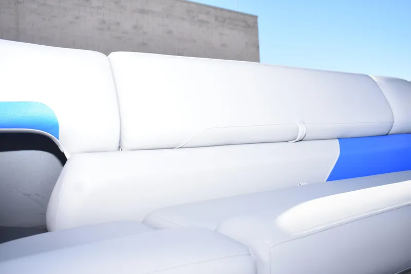 Slide: The Image of 2026 Sun Tracker Party Barge 20 DLX boat seating, featuring white and blue upholstery. - 12