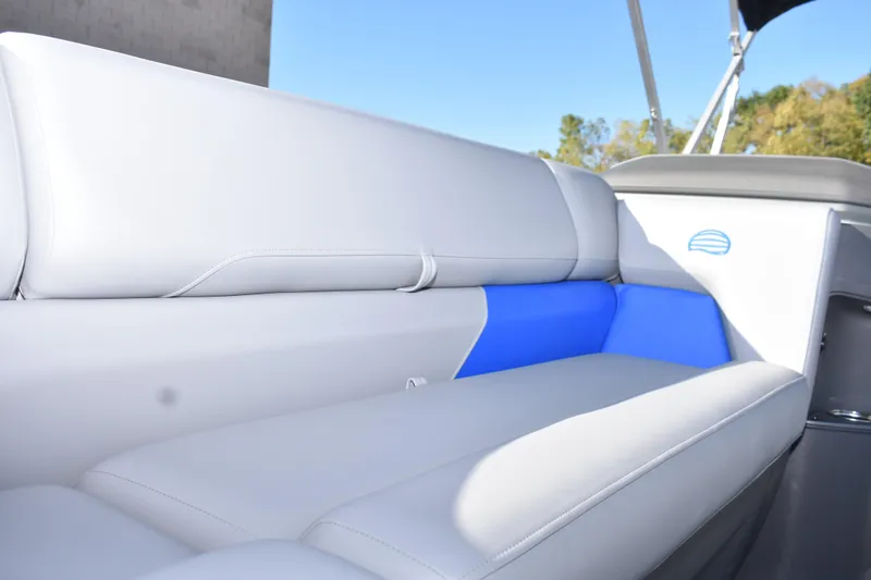 Slide: The Image of 2026 Sun Tracker Party Barge 20 DLX interior seating with blue accent. - 13