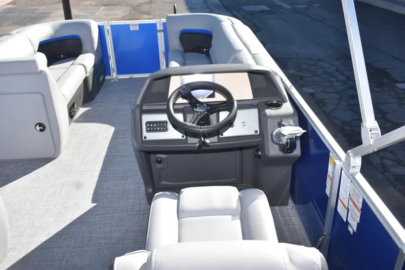 Slide: The Image of 2026 Sun Tracker Party Barge 20 DLX interior with steering console and seating. - 16