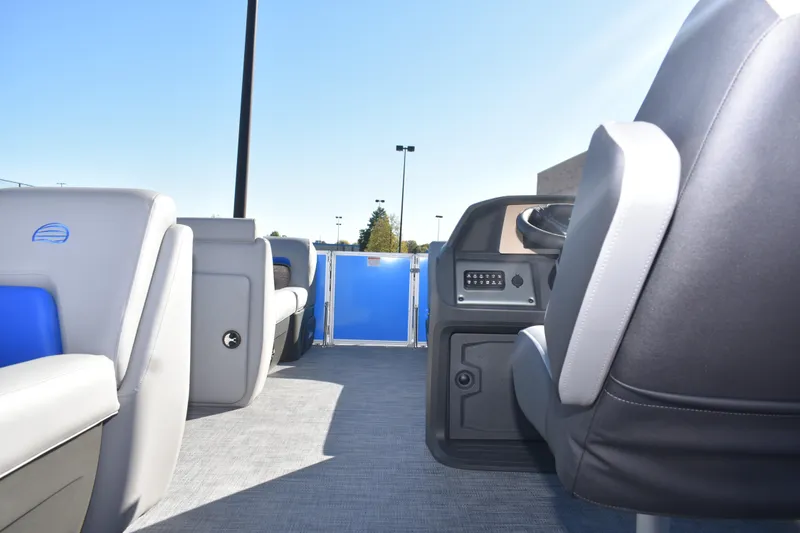 Slide: The Image of 2026 Sun Tracker Party Barge 20 DLX interior with seating and steering console. - 19
