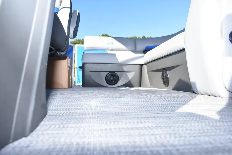 Slide: The Image of 2026 Sun Tracker Party Barge 20 DLX interior with seating and speakers. - 21