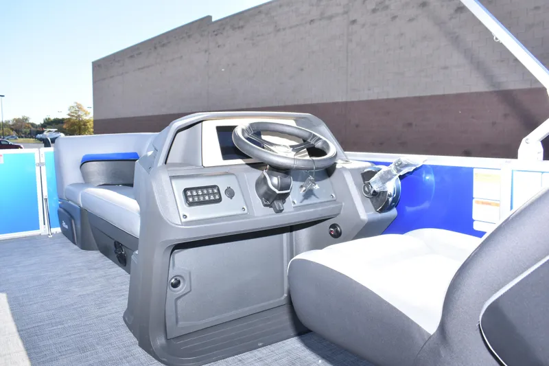 Slide: The Image of 2026 Sun Tracker Party Barge 20 DLX interior with steering console and seating. - 24