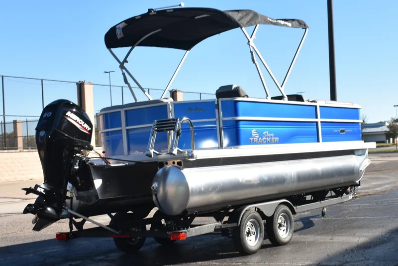 Slide: The Image of 2026 Sun Tracker Party Barge 20 DLX pontoon boat with Mercury outboard motor on trailer. - 3