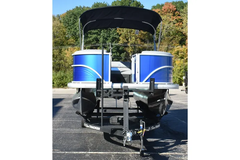 Slide: The Image of 2026 Sun Tracker Party Barge 20 DLX pontoon boat on trailer, parked outdoors. - 5