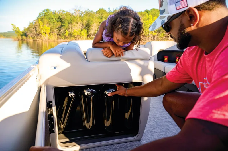 Slide: The Image of Manufacturer Provided Image: Man and child exploring storage on 2026 Sun Tracker Party Barge 20 DLX boat. - 84