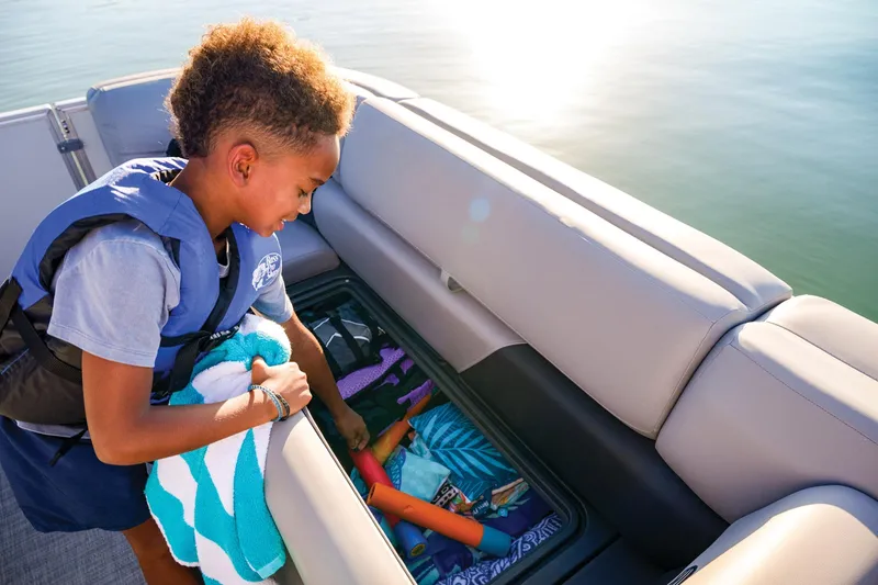 Slide: The Image of Manufacturer Provided Image: Child exploring storage on 2026 Sun Tracker Party Barge 20 DLX pontoon boat. - 85
